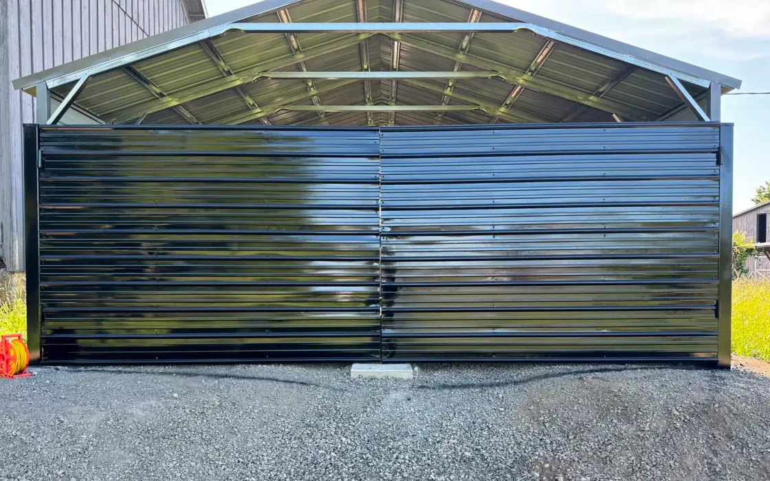 Glossy black metal double swing gate closing steel carport bay. Fence & gate installation in Damascus