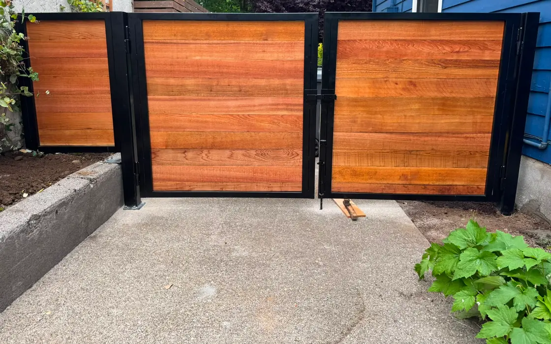 Horizontal cedar swing gates with black steel frames in narrow side yard. Fence & gate installation in Gresham