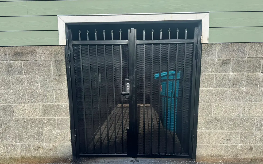 Black steel double security gate with spear tops and keypad, front view. Fence & gate installation in Lake Oswego