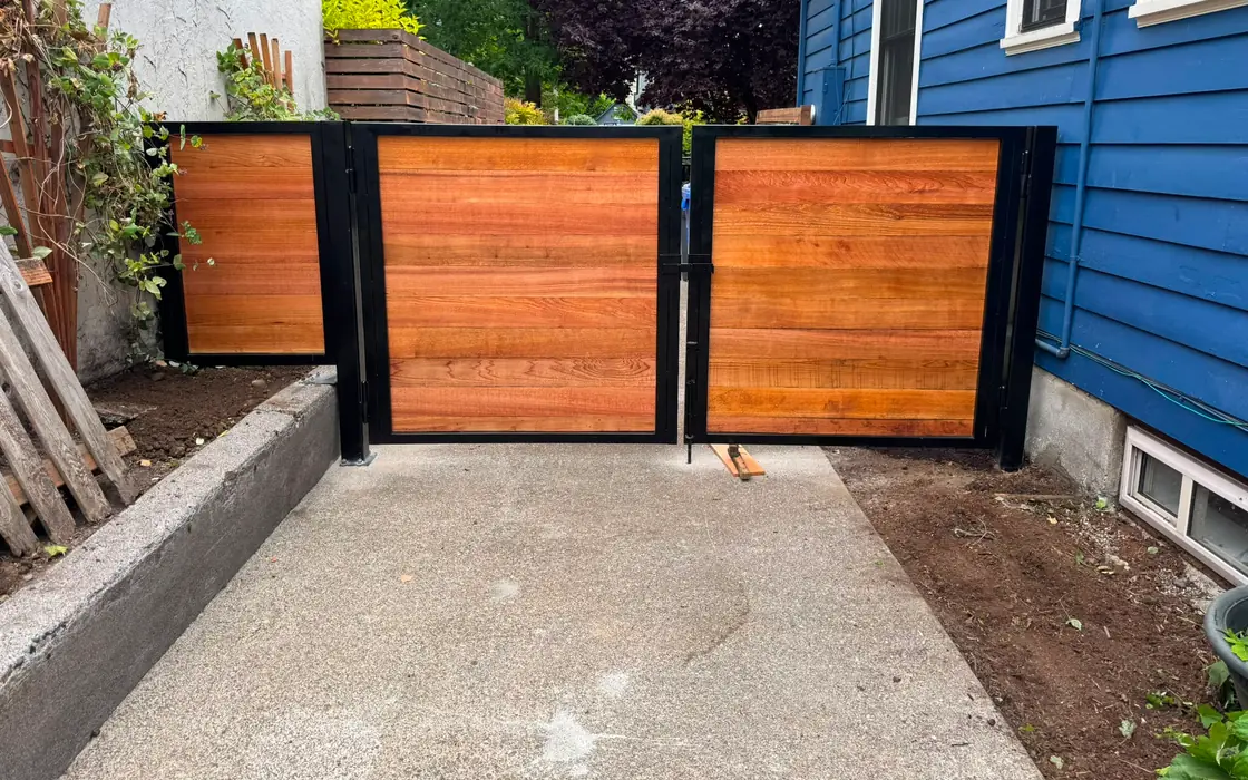 Finished horizontal cedar gates with black steel frames across driveway. Fence & gate installation in Troutdale