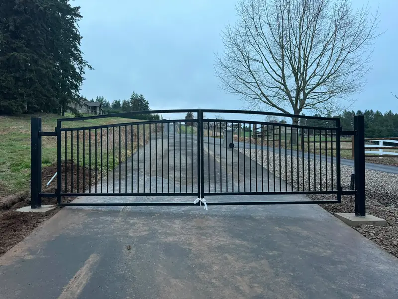 Sliding or swing: choosing the driveway gate your site can live with