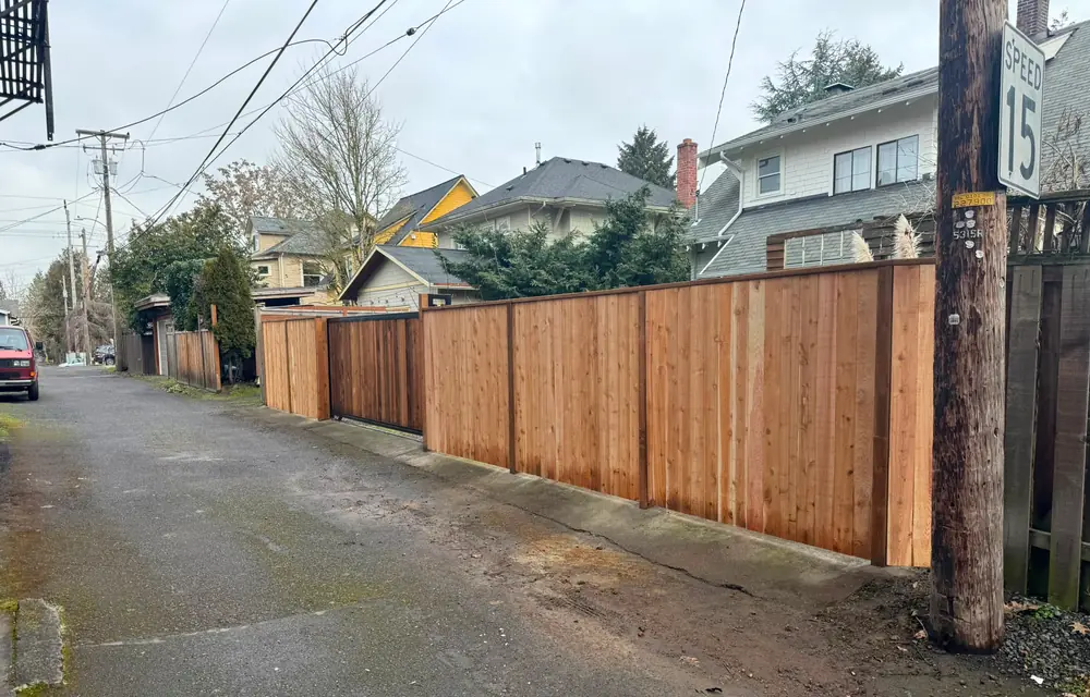New cedar privacy fence with slide gate running along alley near speed 15 sign. Fencing in Felida